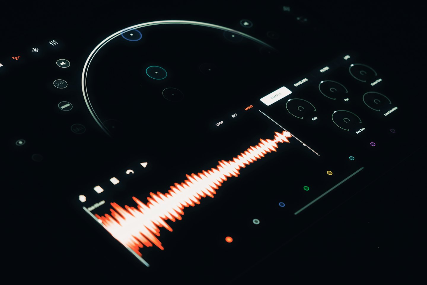 Digital audio workstation interface with orange waveform on dark screen.